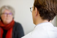 Arzt spricht mit Brustkrebspatientin